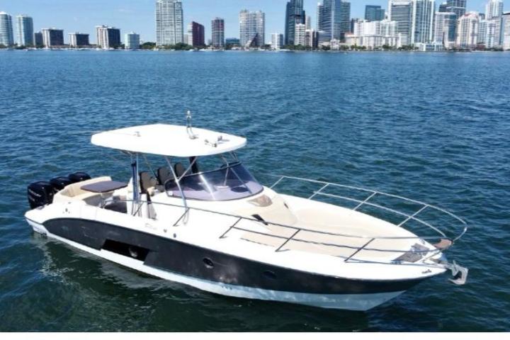 a small boat in a body of water with a city in the background