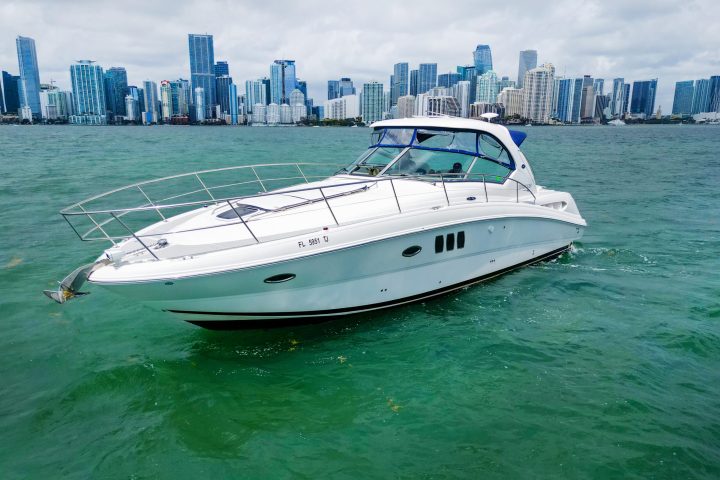 a small boat in a body of water with a city in the background